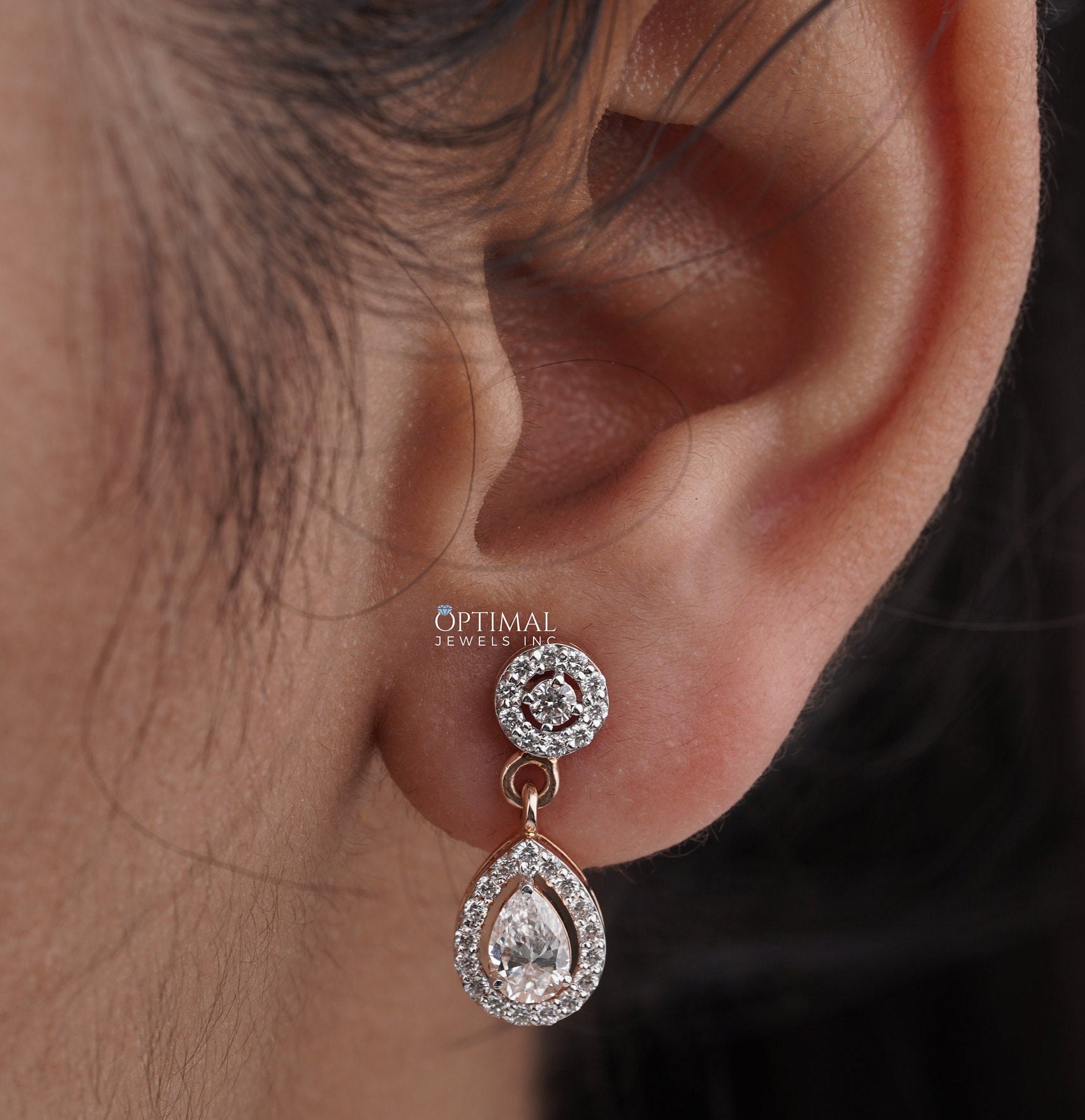 Elegant 2.00 CTW Round and Pear Lab-Grown Diamond earrings in a two-stone halo design, showcasing brilliant sparkle and modern elegance.