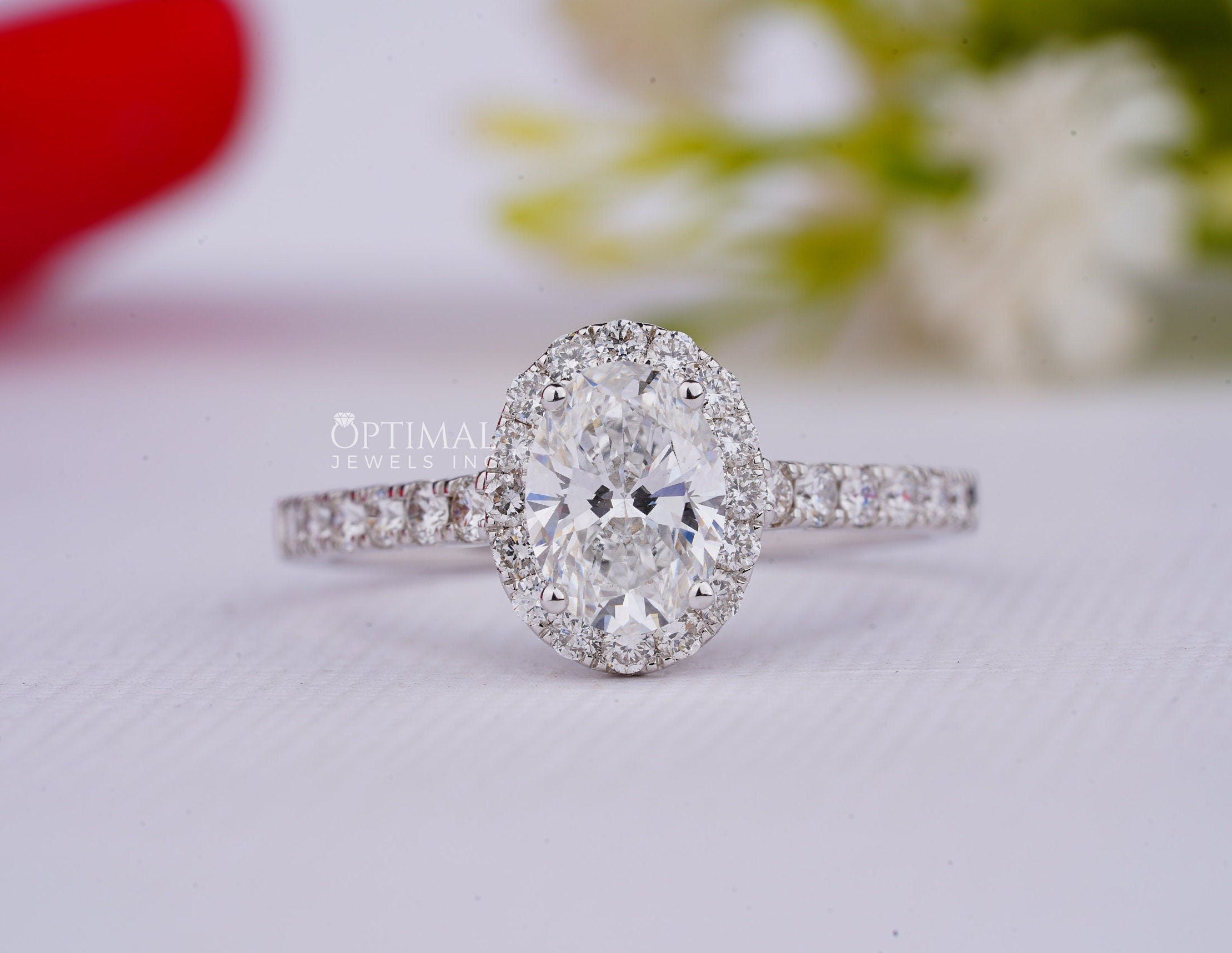 A stunning 2.00CT oval cut lab grown diamond ring with a halo setting, showcasing its brilliance and elegance.