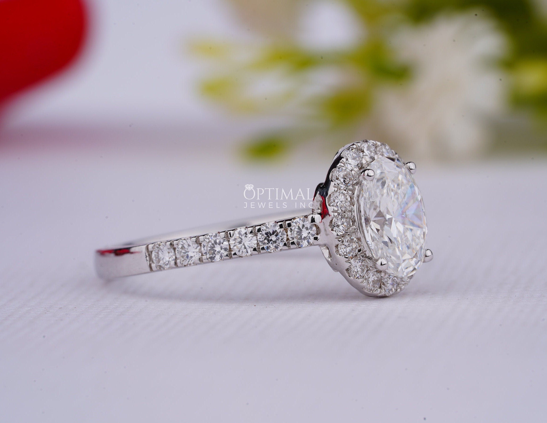 A stunning 2.00CT oval cut lab grown diamond ring with a halo setting, showcasing its brilliance and elegance.