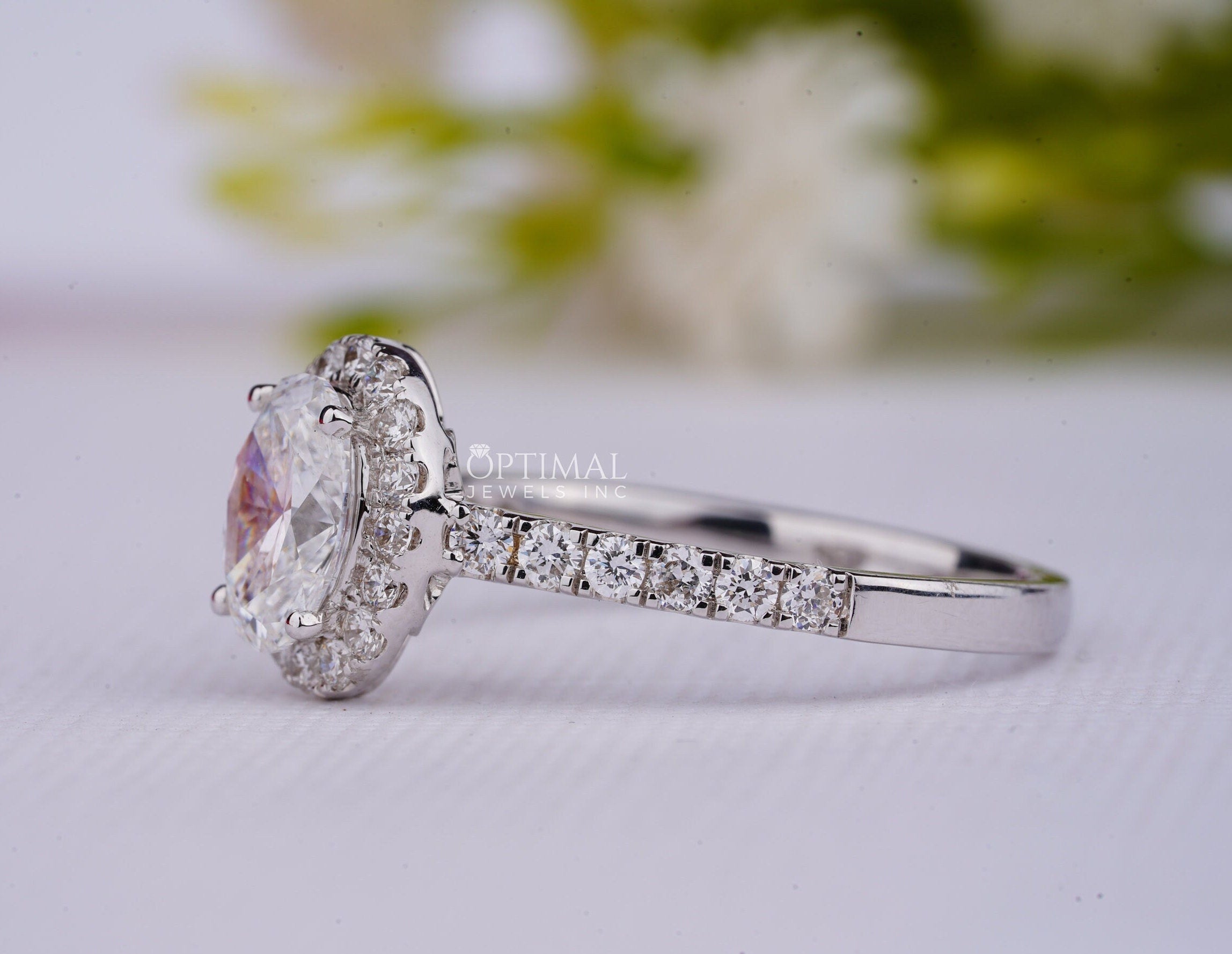 A stunning 2.00CT oval cut lab grown diamond ring with a halo setting, showcasing its brilliance and elegance.