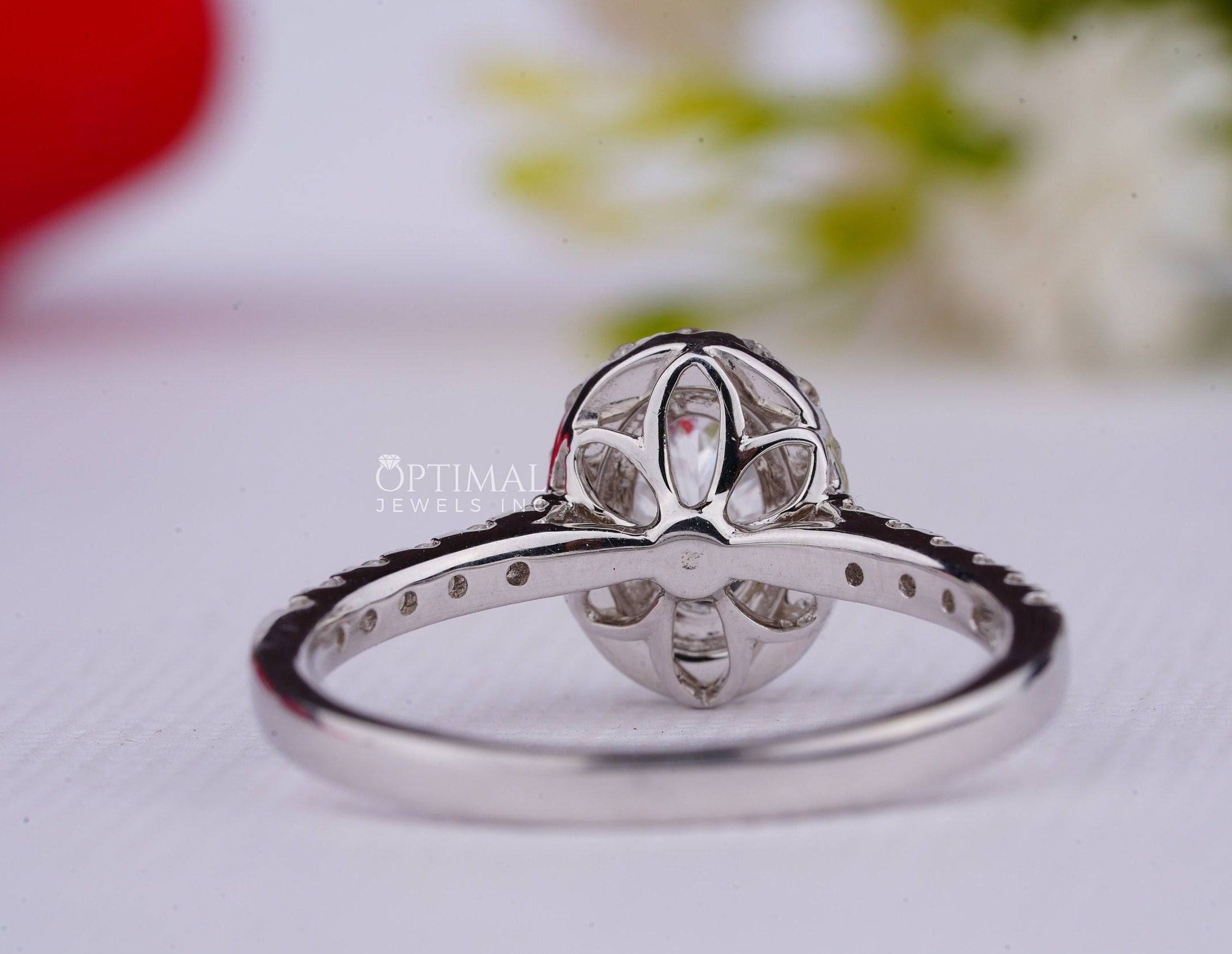 A stunning 2.00CT oval cut lab grown diamond ring with a halo setting, showcasing its brilliance and elegance.