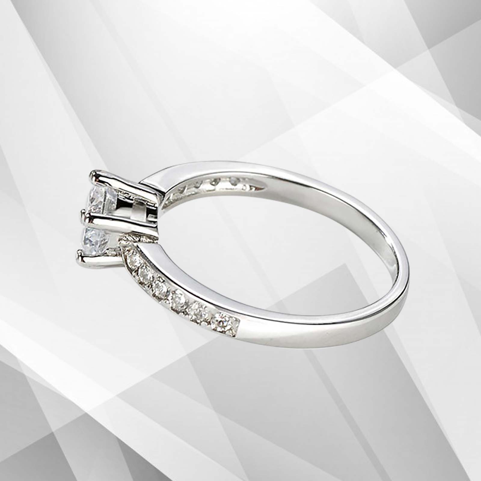 2.0Ct round-cut diamond solitaire engagement ring in 18Ct white gold setting, featuring 6 claw prong settings and a brilliant shine.