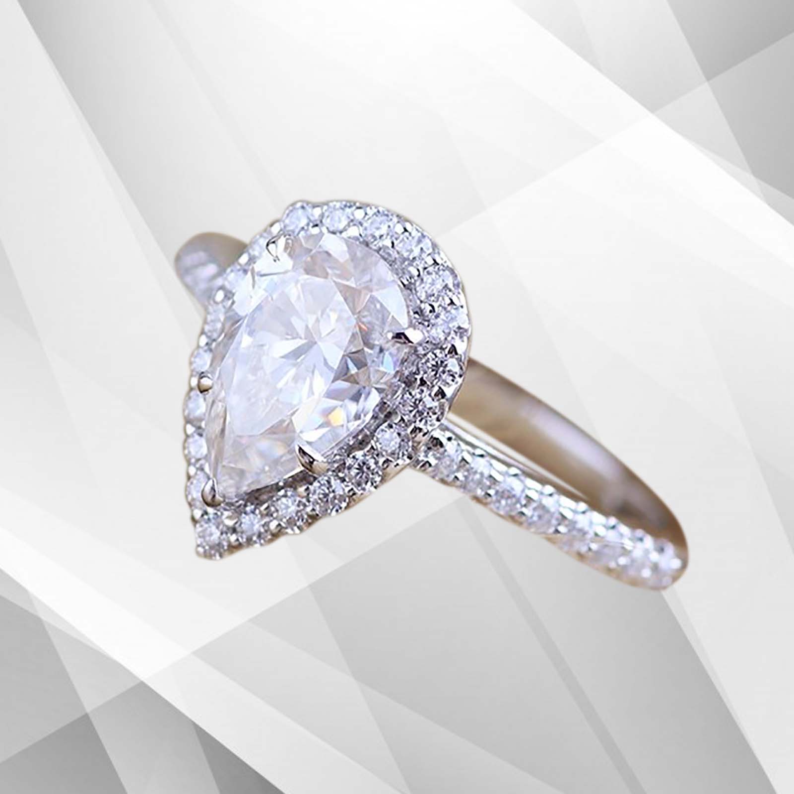2.88Ct pear-cut diamond engagement ring with cushion halo setting in 18Ct white gold, showcasing its brilliance and elegance.