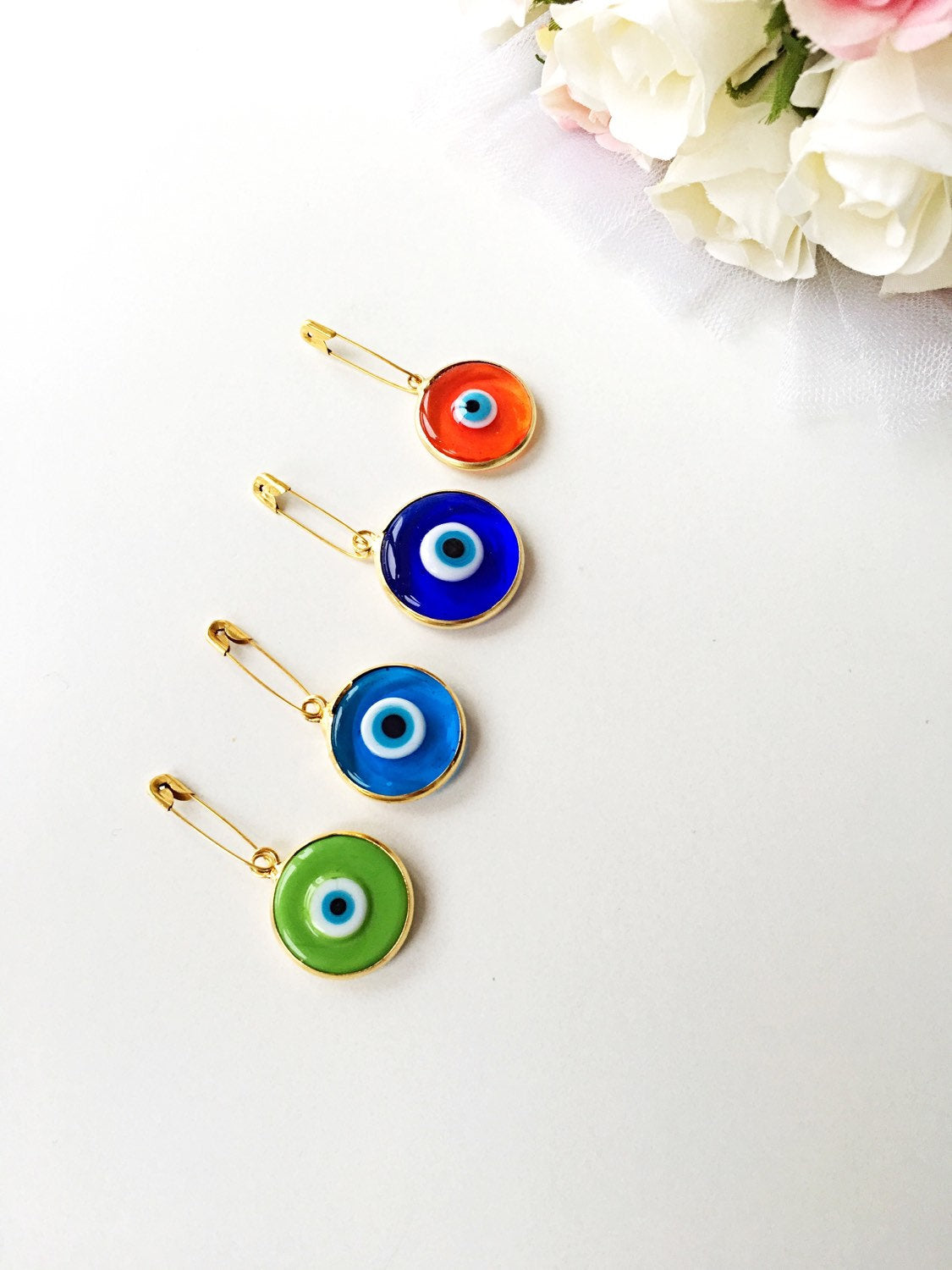 Gold plated 28mm evil eye safety pin with big enamel design, available in four colors for baby protection.