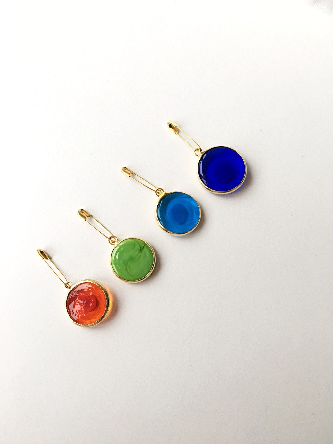 Gold plated 28mm evil eye safety pin with big enamel design, available in four colors for baby protection.
