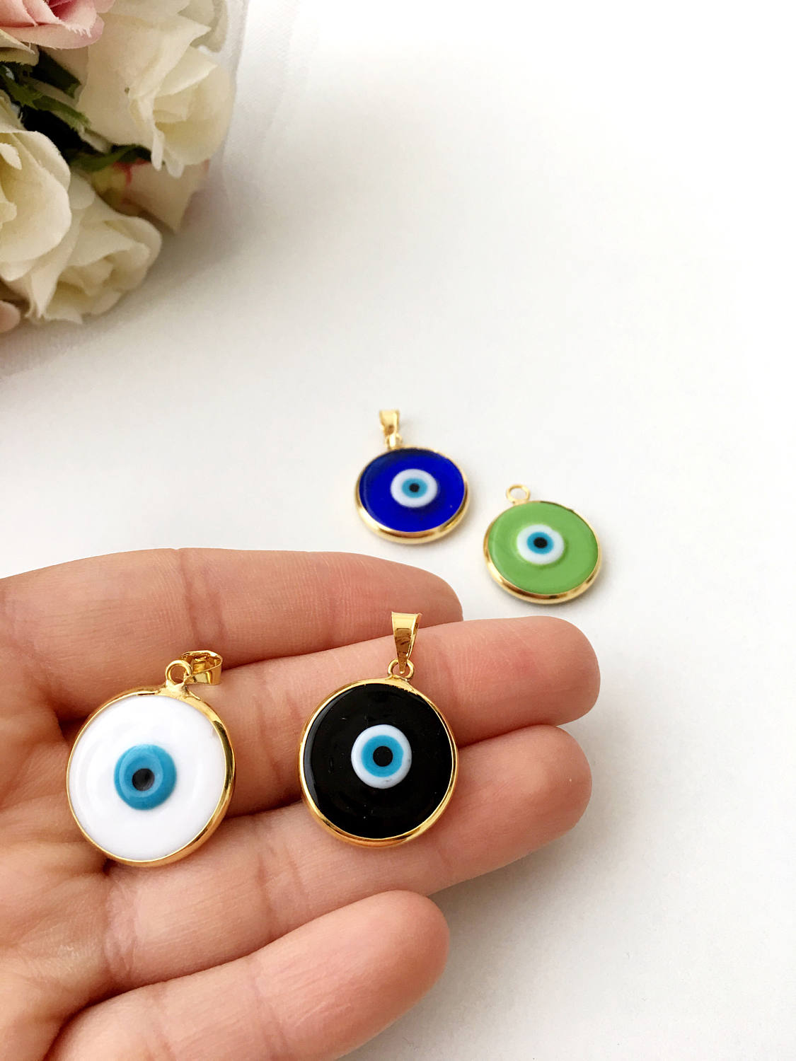 Two glass evil eye beads with 22K matte gold plated brass accents, perfect for necklace making.