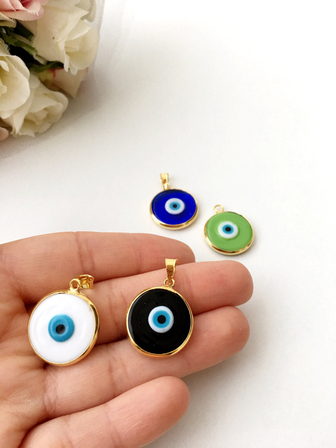 Two glass evil eye beads with gold plating, showcasing dark blue and opaque blue colors, perfect for jewelry making.