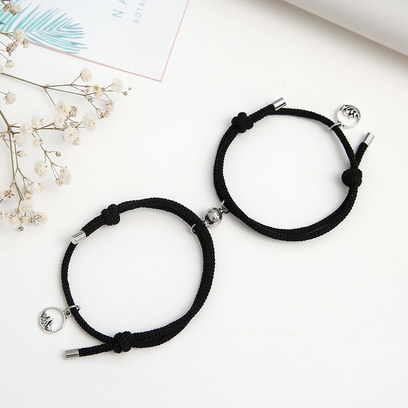 A pair of stylish alloy couple bracelets featuring magnetic attraction balls, symbolizing love and connection.