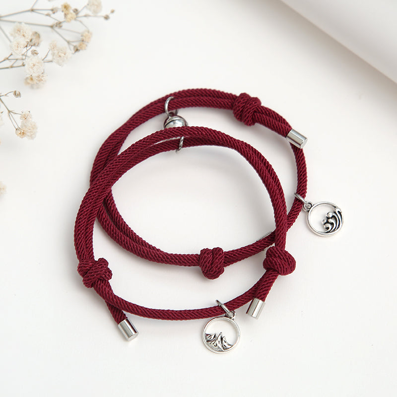 A pair of stylish alloy couple bracelets featuring magnetic attraction balls, symbolizing love and connection.