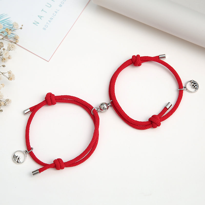 A pair of stylish alloy couple bracelets featuring magnetic attraction balls, symbolizing love and connection.