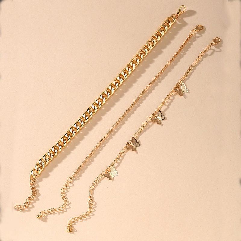 A luxurious 3 Piece Chain and Butterfly Bracelet Set in 18K gold plating, showcasing intricate designs and a comfortable fit.
