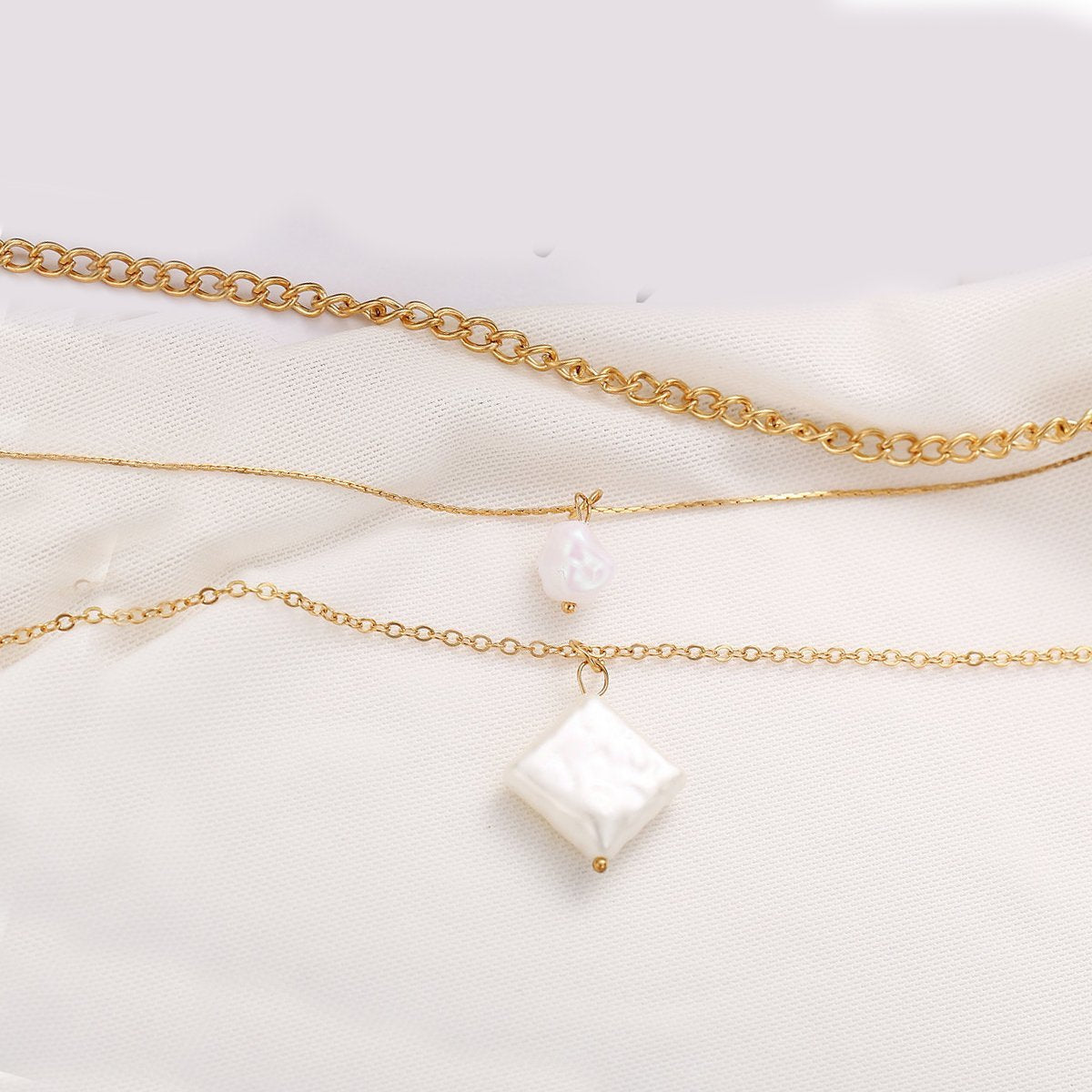 Elegant 3 Piece Pearl Linear Chain Necklace in 18K gold plating, featuring a unique linear design and a lobster clasp closure.