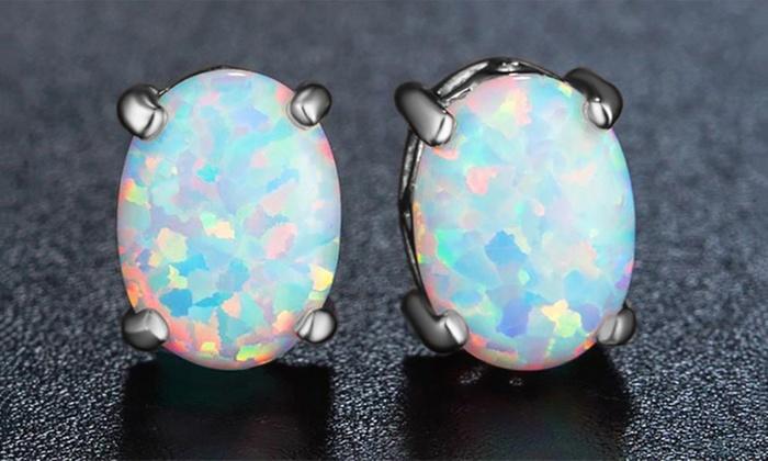 Elegant 3.00 CT oval cut opal stud earrings set in 18K white gold plating, featuring butterfly backing for secure wear.