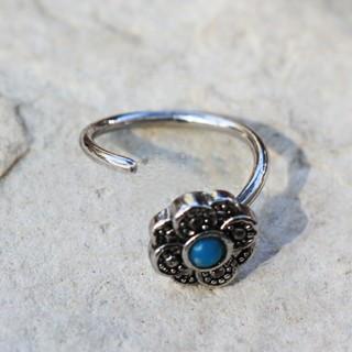 Aqua flower nose hoop earring made of 316L stainless steel with a turquoise bead centerpiece and black plating.