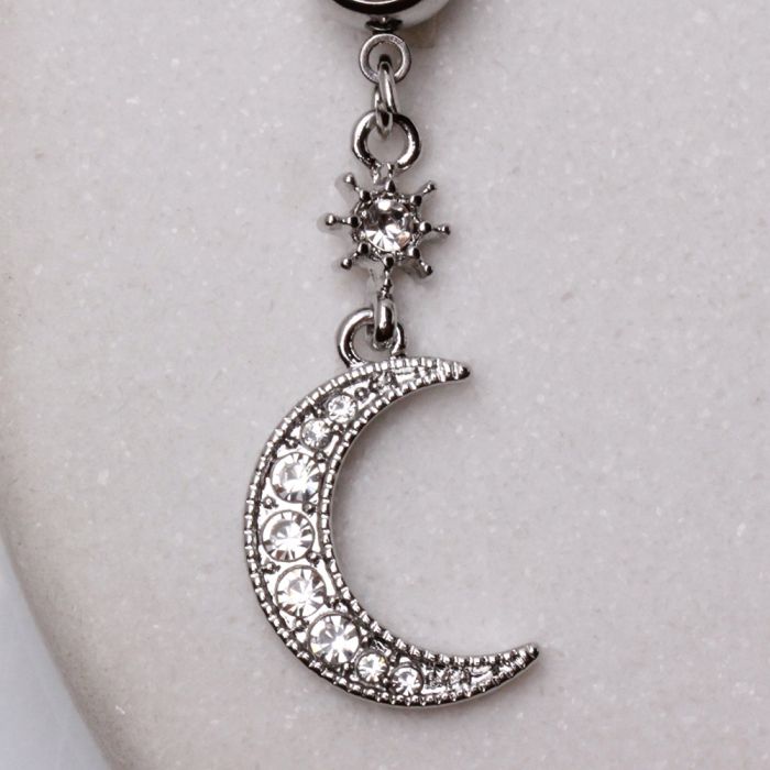 A beautiful 316L stainless steel navel ring featuring a dangle design of a crescent moon and star, adorned with clear cubic zirconia stones.