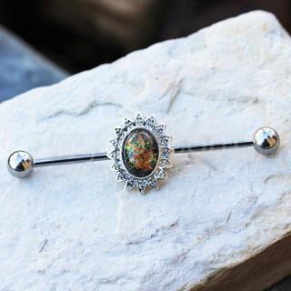 A 316L stainless steel industrial barbell featuring a colorful glass stone flower design with orange, green, and black stones.
