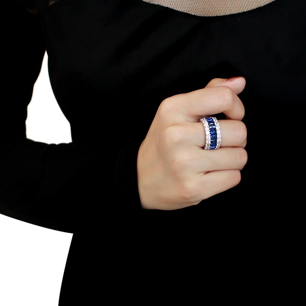A beautiful rhodium brass ring featuring a synthetic Montana stone, showcasing its elegant design and shiny finish.