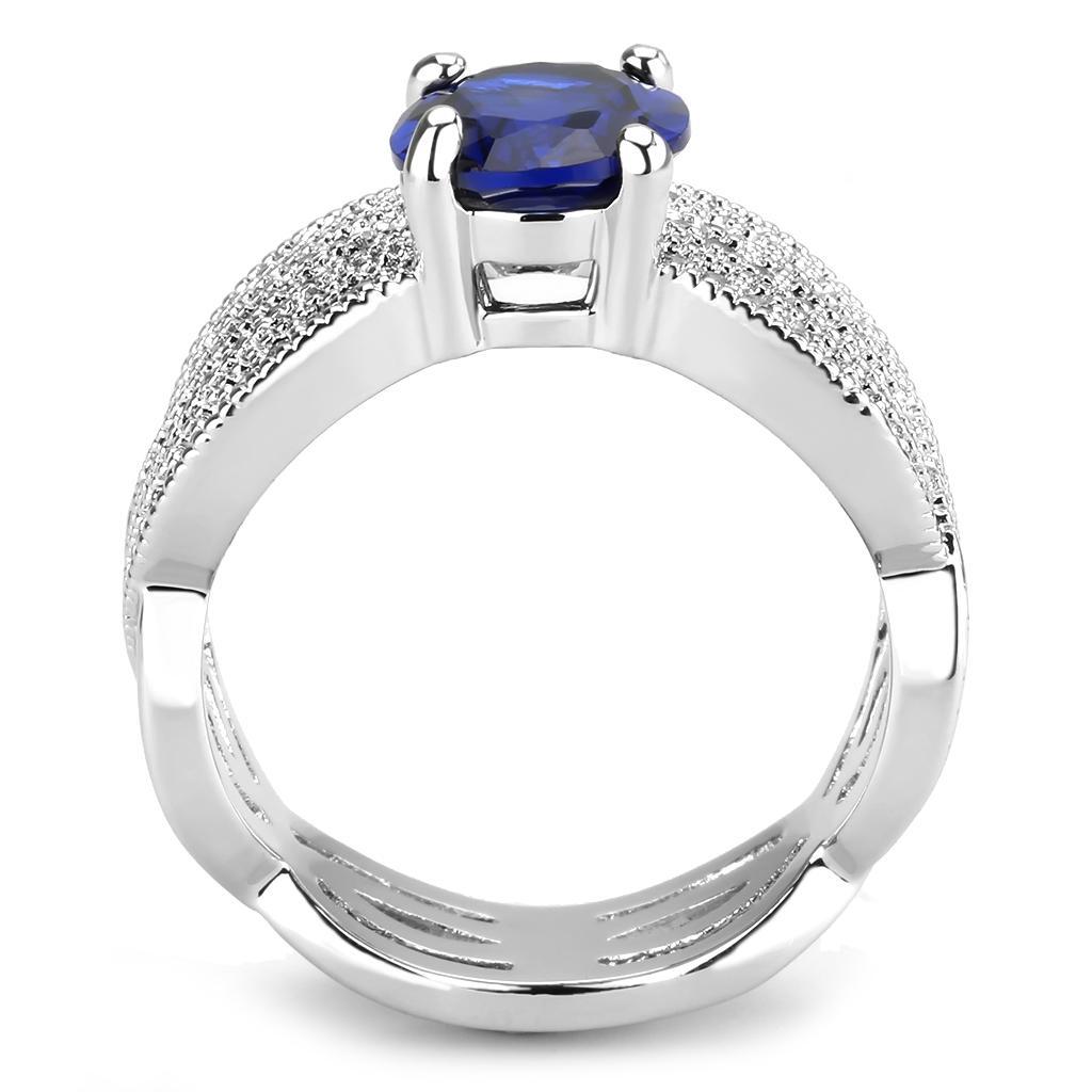 Rhodium brass ring featuring a synthetic London Blue spinel, showcasing its elegant design and vibrant color.