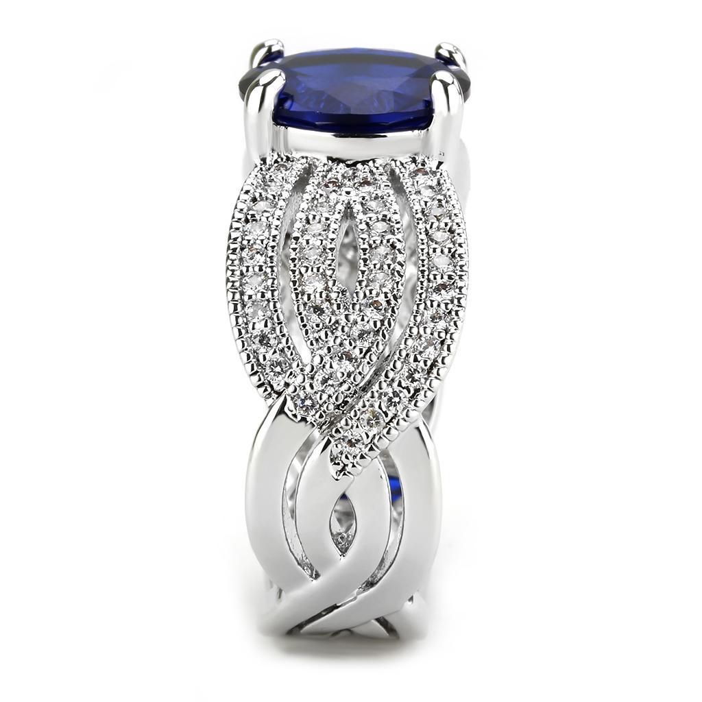 Rhodium brass ring featuring a synthetic London Blue spinel, showcasing its elegant design and vibrant color.