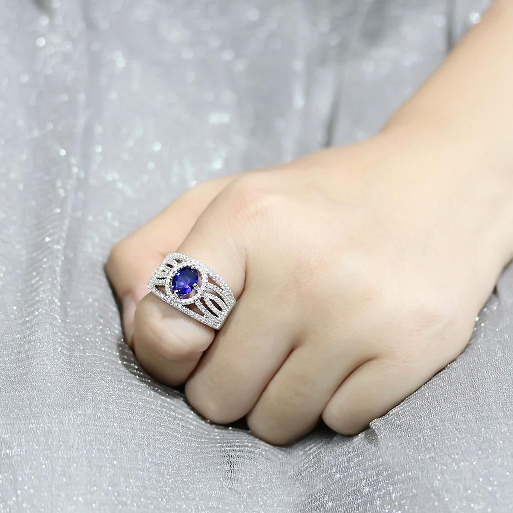 Rhodium brass ring featuring a synthetic London Blue spinel, showcasing its elegant design and vibrant color.