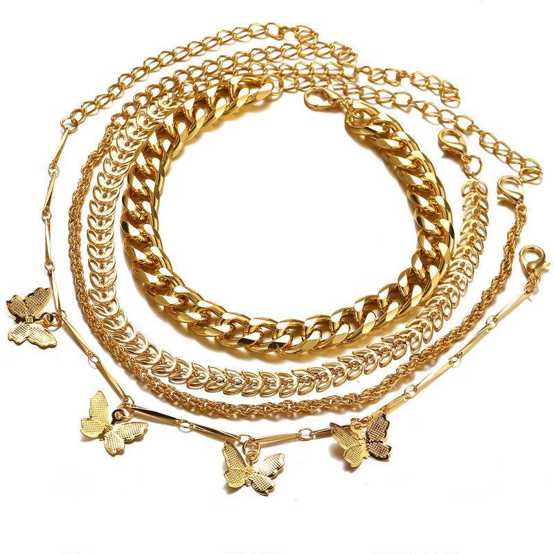 A luxurious 4 Piece Chain and Butterfly Bracelet Set, featuring intricate designs in 18K gold plating, showcasing elegance and style.