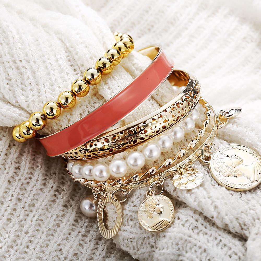 A luxurious 4 piece coral bracelet set, elegantly designed with 18K gold plating, showcasing Italian craftsmanship and vibrant coral accents.