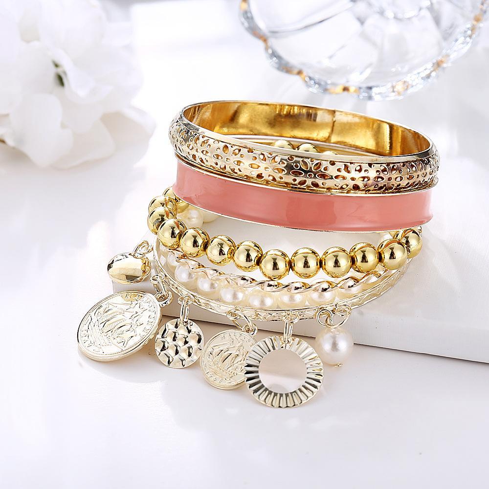 A luxurious 4 piece coral bracelet set, elegantly designed with 18K gold plating, showcasing Italian craftsmanship and vibrant coral accents.