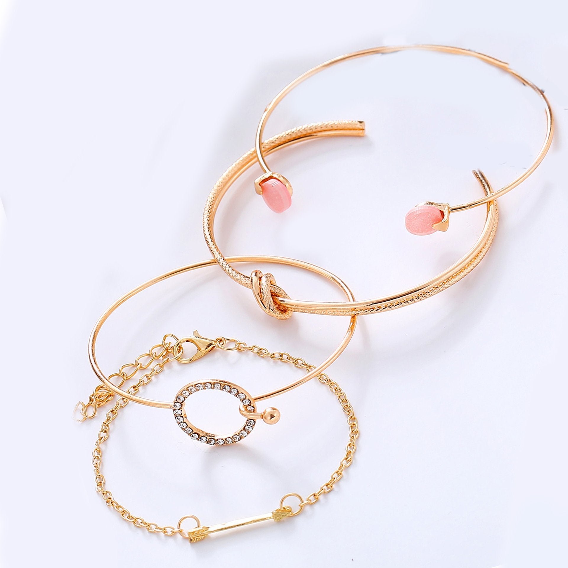 A beautiful 4 Piece Pink Bracelet Set featuring sparkling crystals and 18K gold plating, elegantly displayed on a soft background.