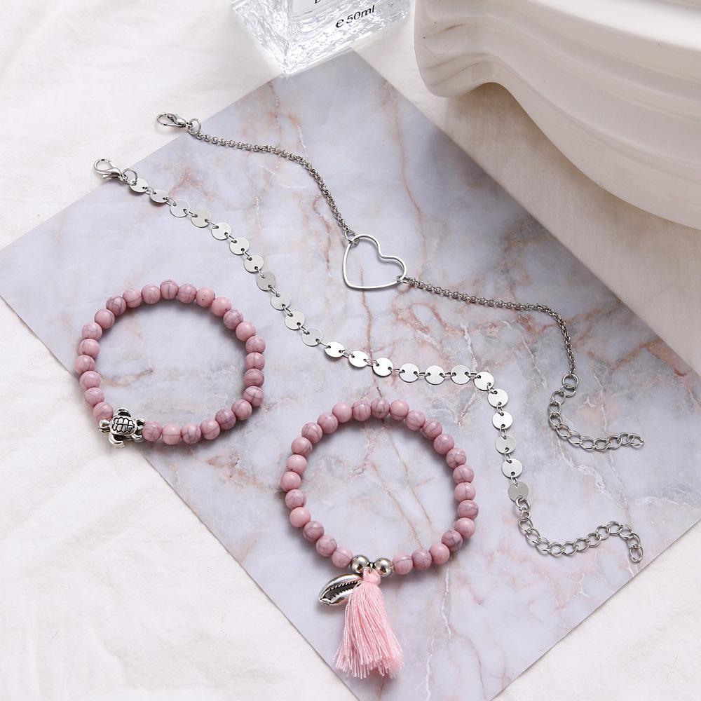 4 Piece Pink Tassel Bracelet Set featuring 18K white gold plating, showcasing elegant pink tassels and a comfortable fit.