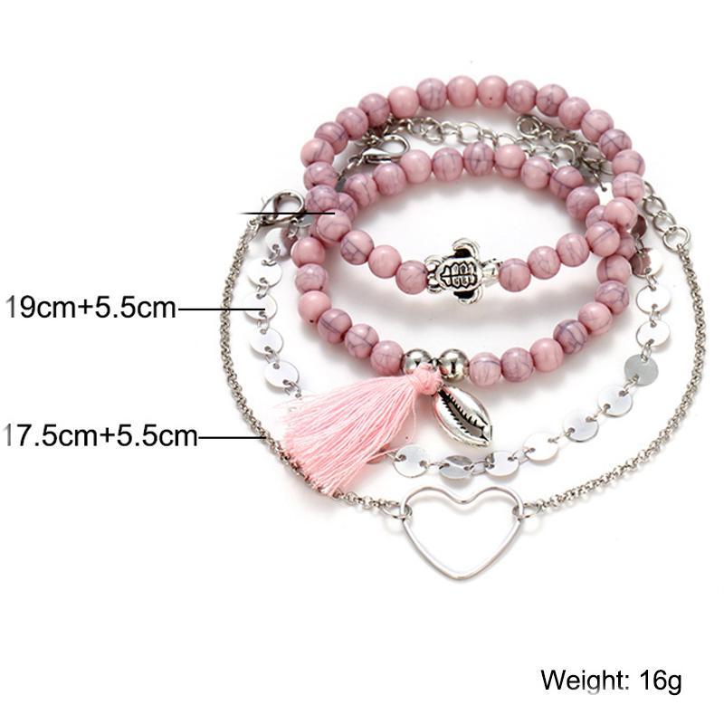 4 Piece Pink Tassel Bracelet Set featuring 18K white gold plating, showcasing elegant pink tassels and a comfortable fit.