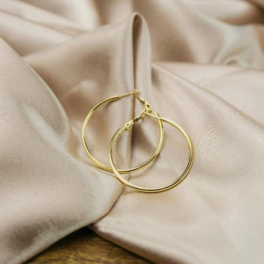 A pair of 40MM gold large round dainty minimal pipe threader statement hoop earrings, showcasing a sleek and elegant design.