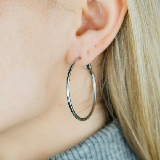 A pair of 40MM gold large round dainty minimal pipe threader statement hoop earrings, showcasing a sleek and elegant design.