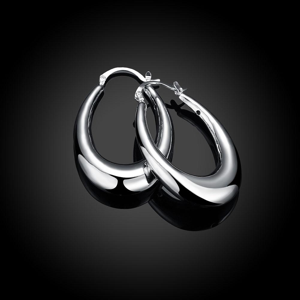 A pair of 47mm thick cut hoop earrings in 18K white gold plating, showcasing a sleek and elegant design.