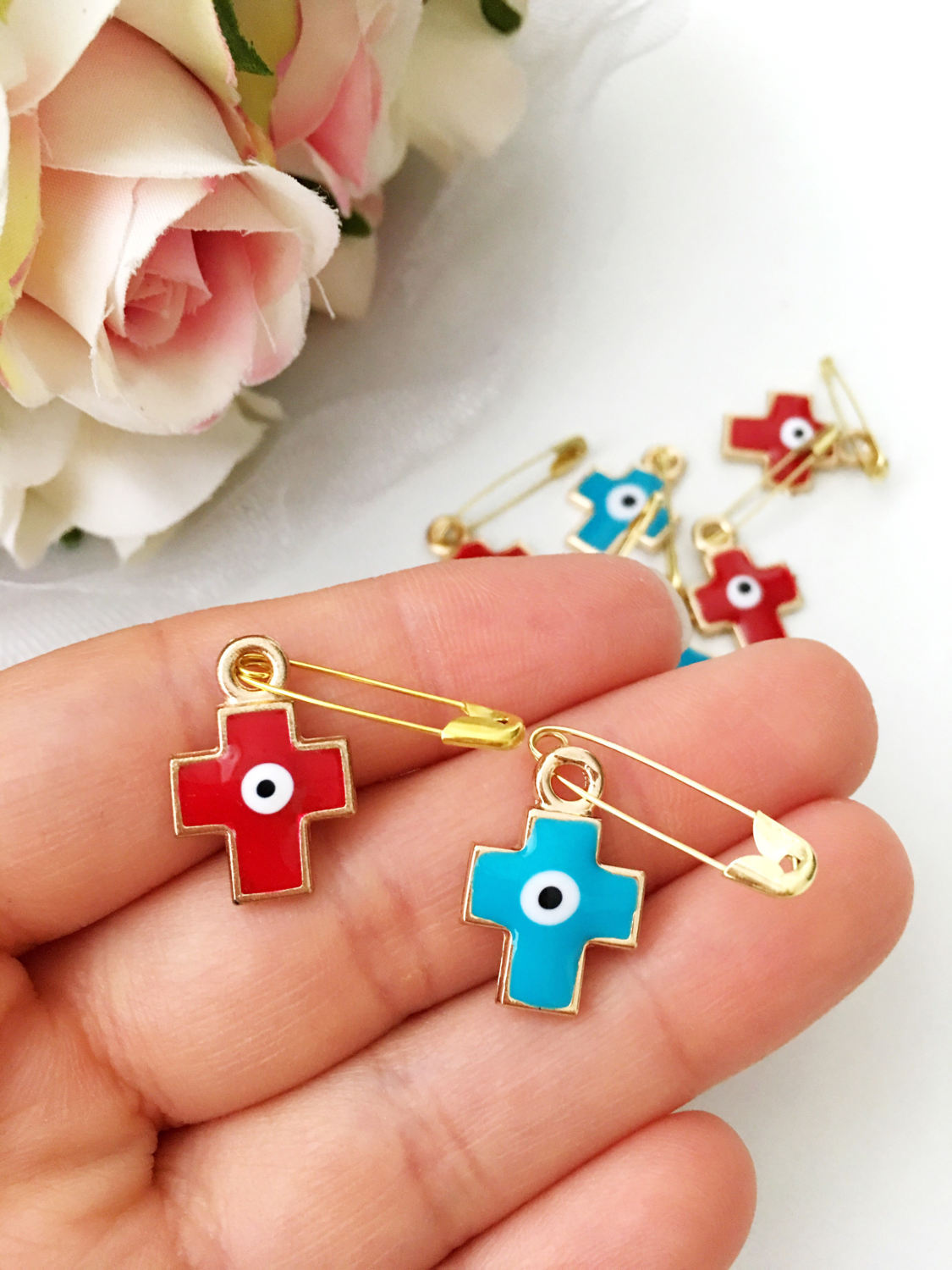 Set of 5 cross evil eye safety pins in red and turquoise, featuring gold plating and big enamel evil eye charms for baby protection.