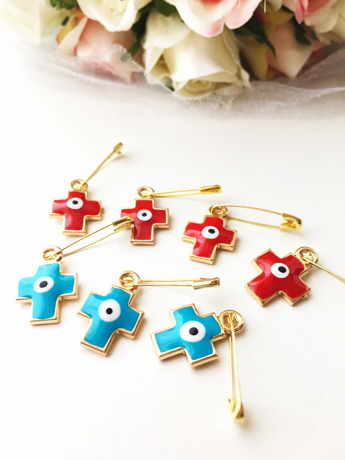 Set of 5 cross evil eye safety pins in red and turquoise, featuring gold plating and big enamel evil eye charms for baby protection.