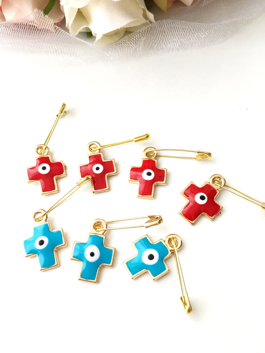Set of 5 cross evil eye safety pins in red and turquoise, featuring gold plating and big enamel evil eye charms for baby protection.