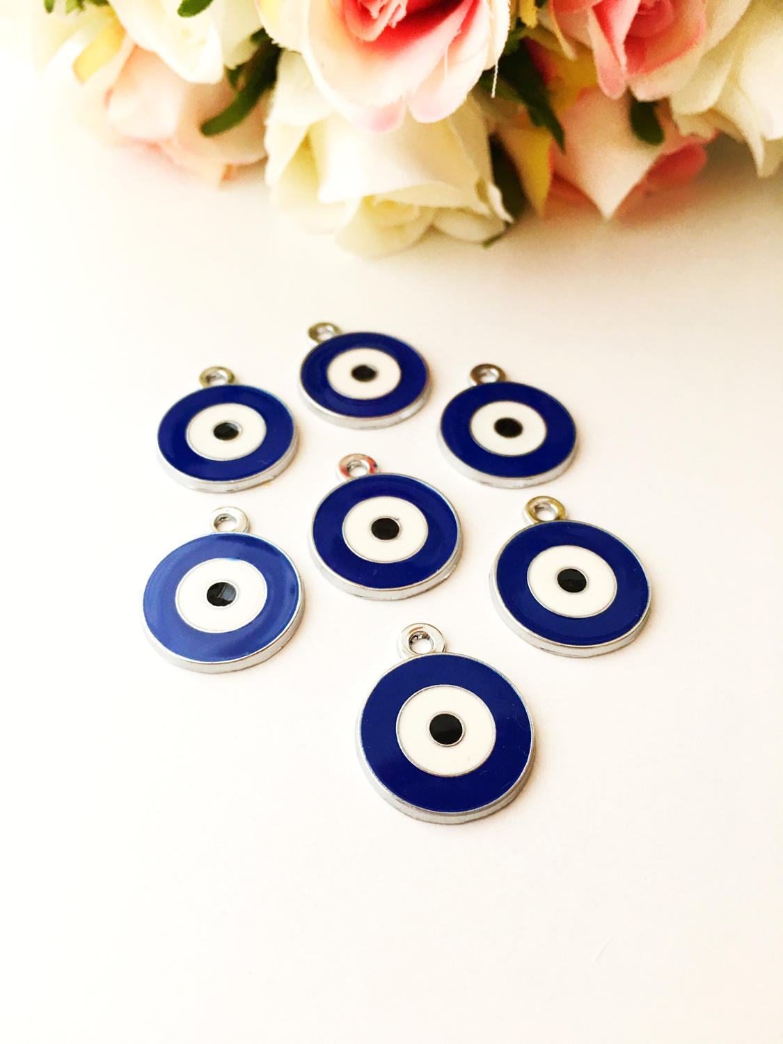Five 20mm brass evil eye charms with blue enamel design, ideal for jewelry making.