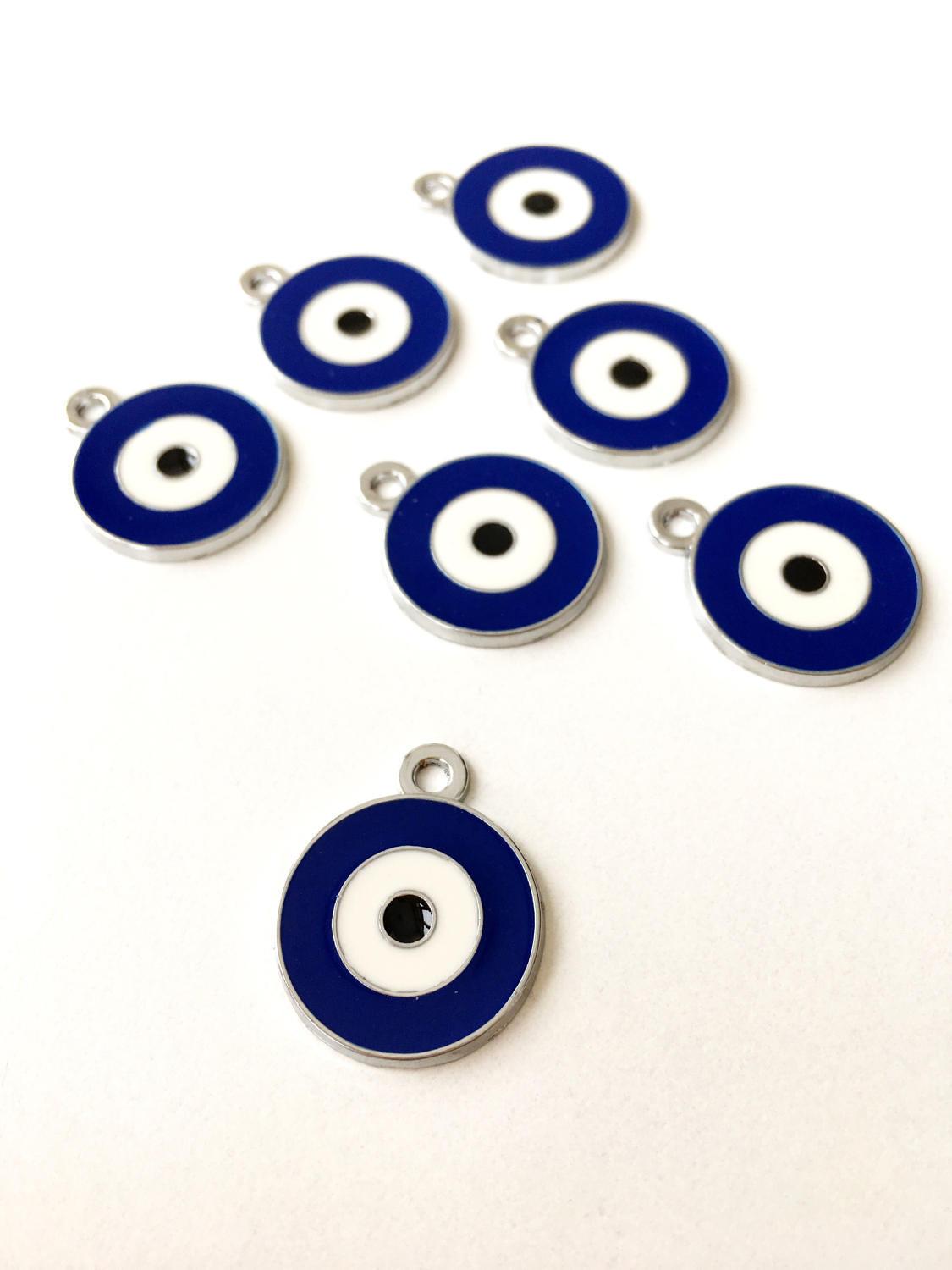 Five 20mm brass evil eye charms with blue enamel design, ideal for jewelry making.