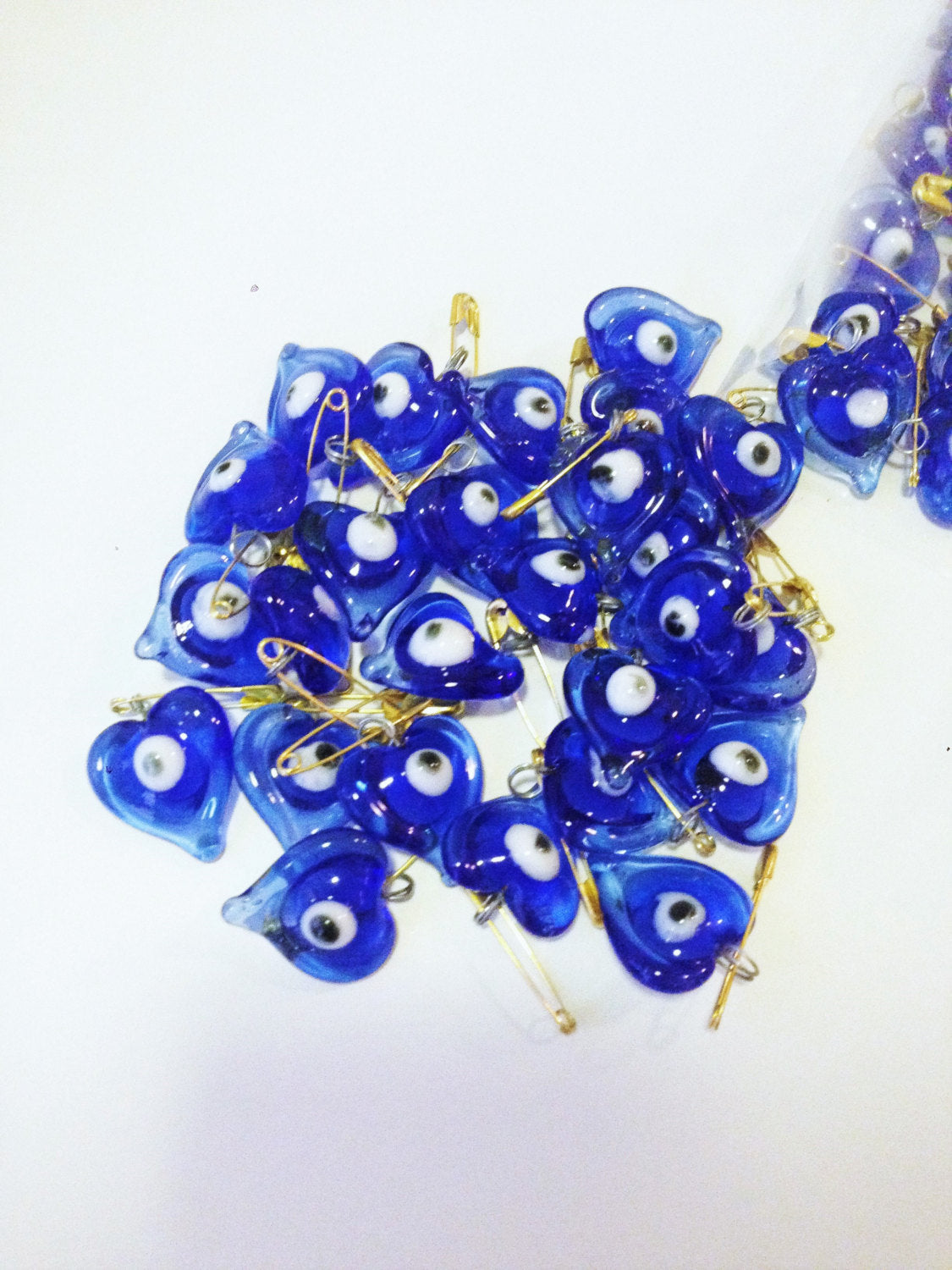 Set of 5 heart-shaped glass evil eye safety pins, perfect for wedding favors and baby showers, showcasing vibrant evil eye beads.