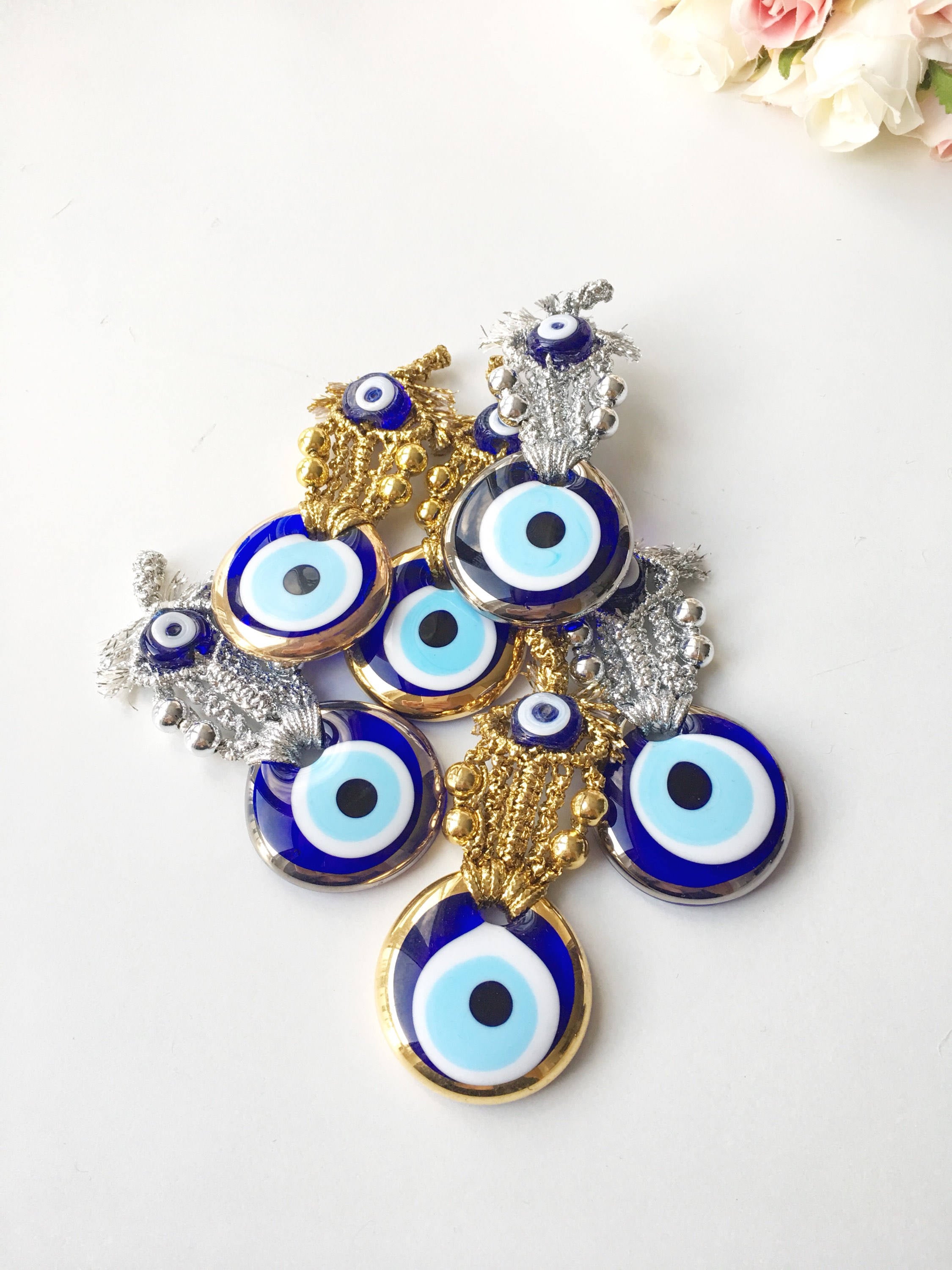 Set of 5 handmade evil eye wedding favors in gold and silver, featuring nazar boncuk charms, perfect for guest gifting.