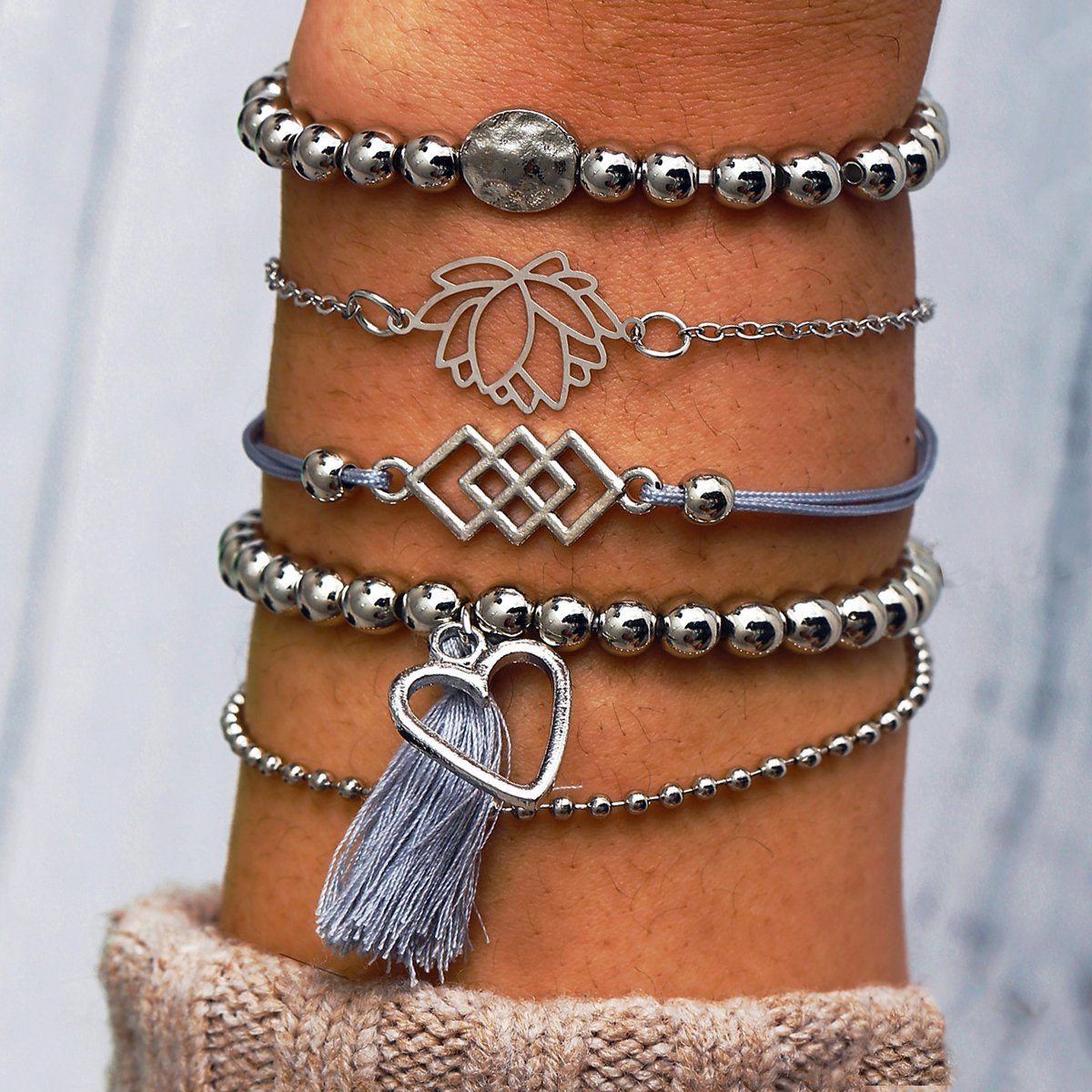 5 Piece Gray Tassell Bracelet Set featuring 18K white gold plating, showcasing elegant gray tassels and a comfortable fit.