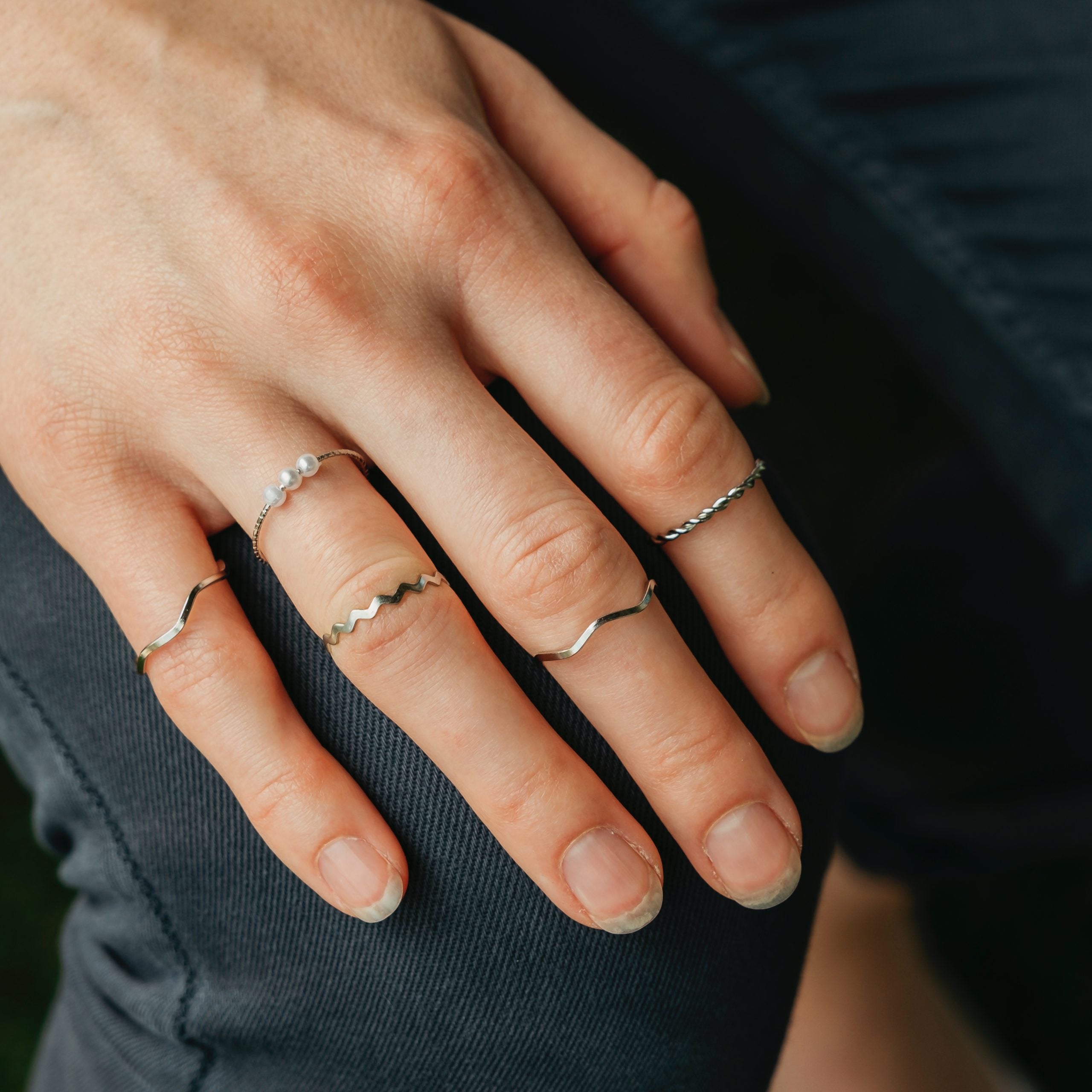 5 Piece Slim Silver Bohemian Pearl Tribal Midi Stackable Ring Set displayed elegantly, showcasing their minimalist design and high-quality finish.