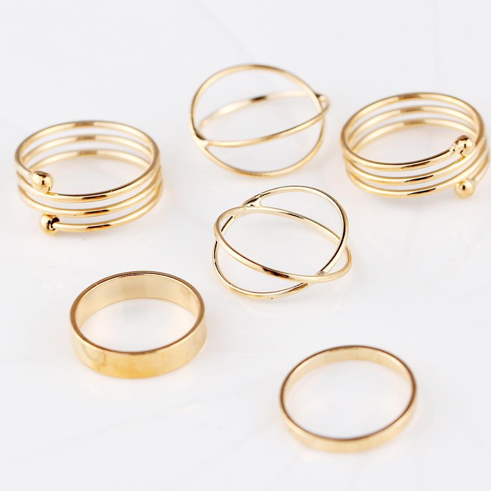 A stylish 6 piece geometric ring set made of 18K gold plated jewelry, showcasing unique designs and a luxurious finish.
