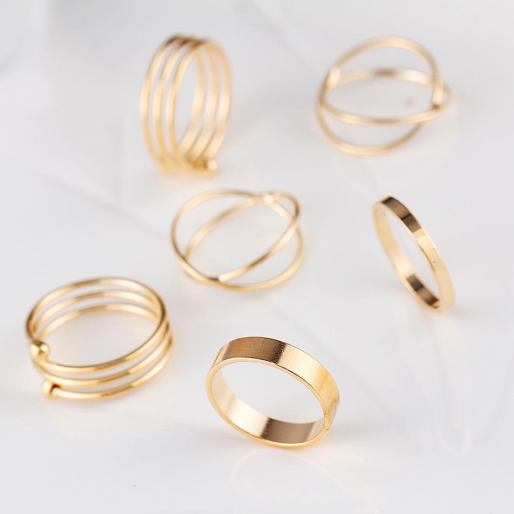 A stylish 6 piece geometric ring set made of 18K gold plated jewelry, showcasing unique designs and a luxurious finish.