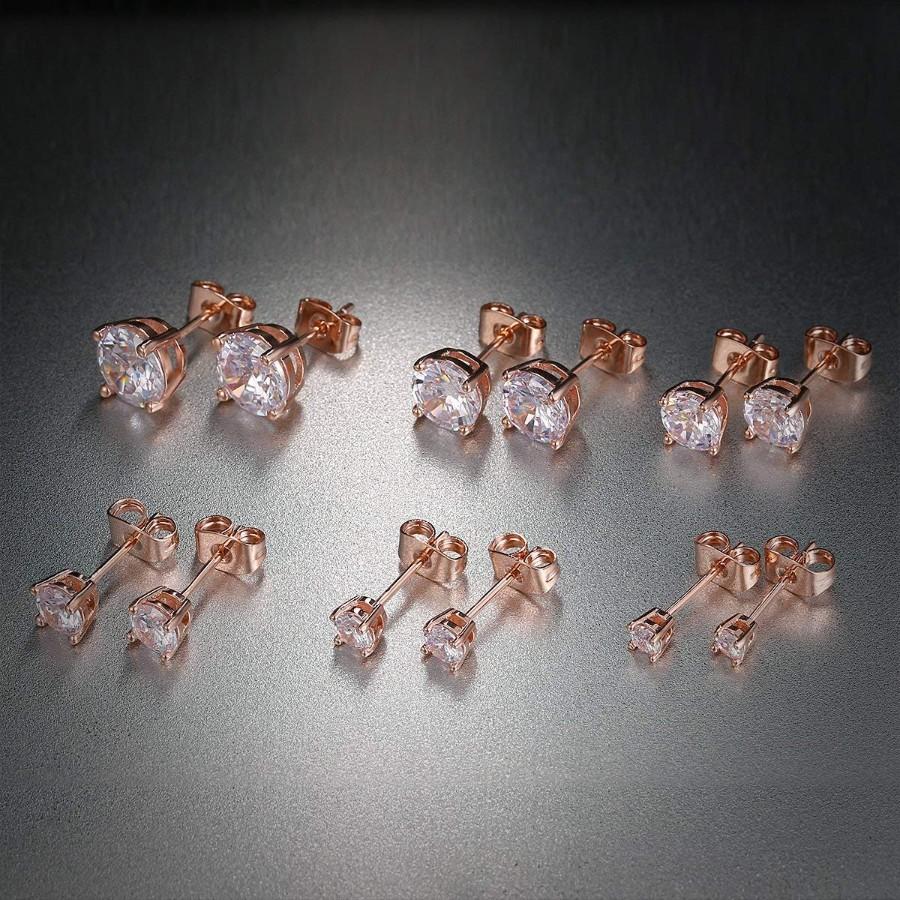 A set of 6 graduating classic elements studs in 14K rose gold plated, featuring princess cut white stones, elegantly displayed on a soft background.