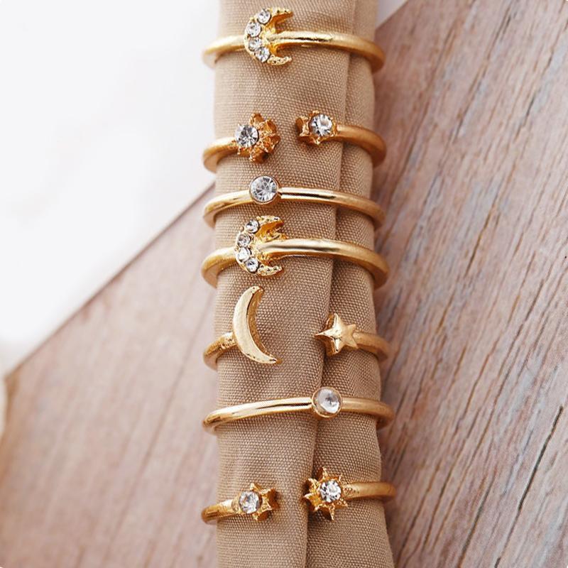 A beautiful 7 piece ring set featuring moon and stars designs, adorned with sparkling gemstone crystals, plated in 18K gold.