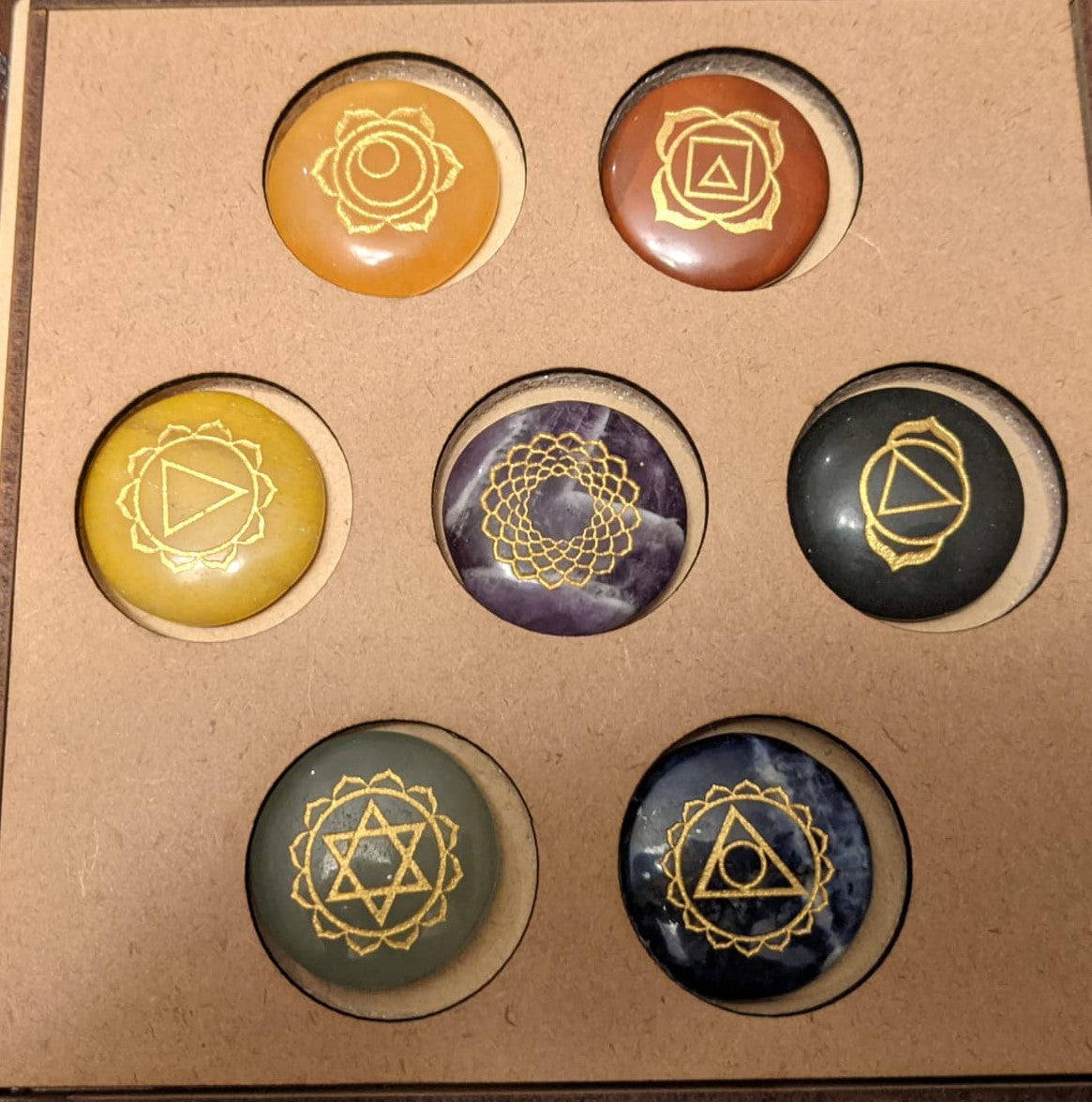 7 Stone Chakra Set Palm Stones with engraved symbols, beautifully polished and presented in a box, ideal for meditation and healing.