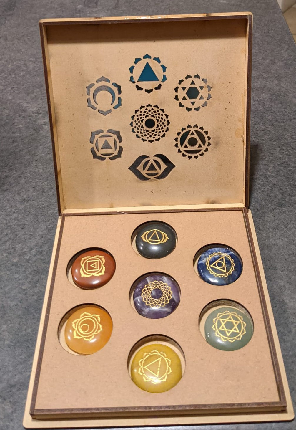 7 Stone Chakra Set Palm Stones with engraved symbols, beautifully polished and presented in a box, ideal for meditation and healing.