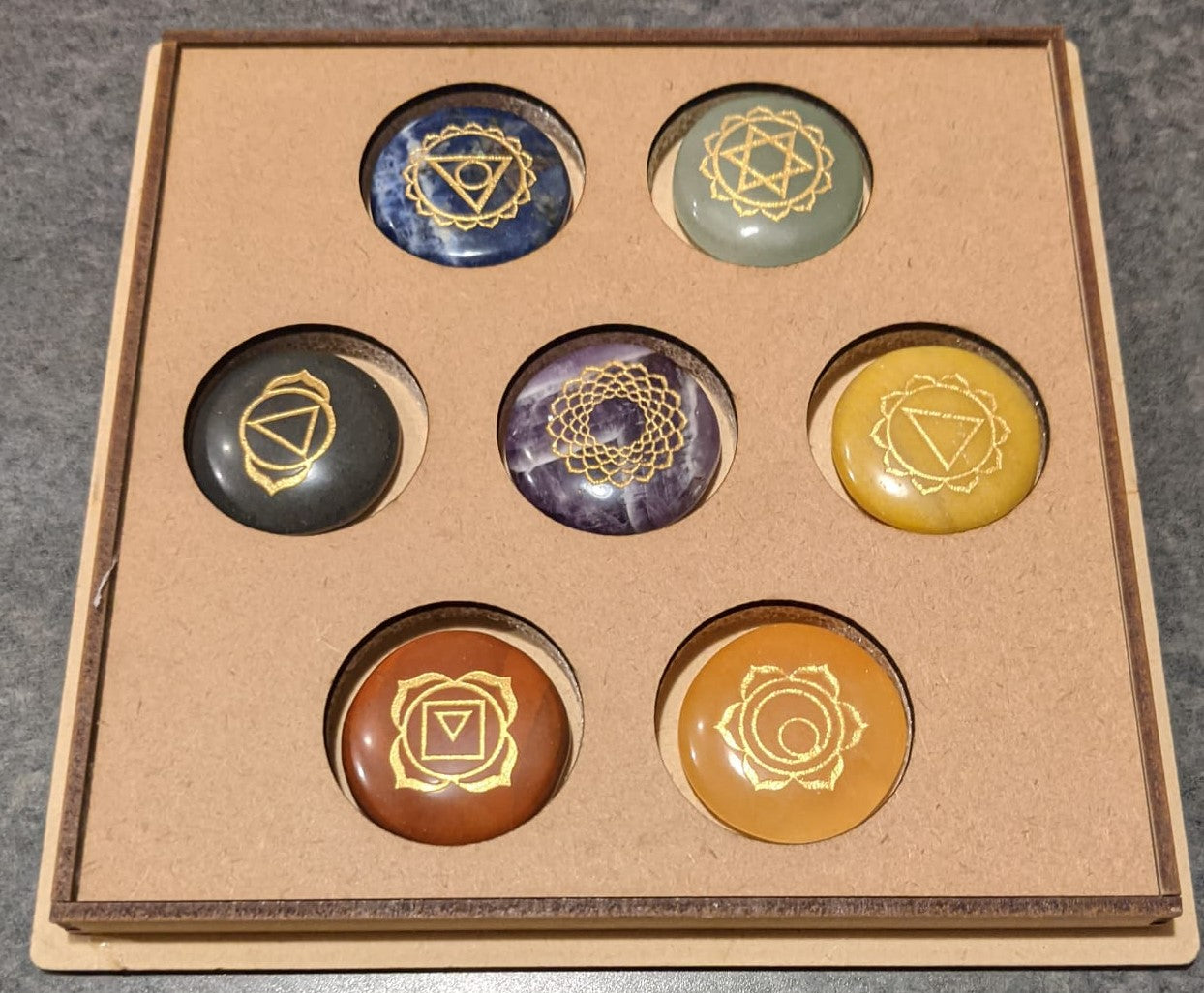 7 Stone Chakra Set Palm Stones with engraved symbols, beautifully polished and presented in a box, ideal for meditation and healing.
