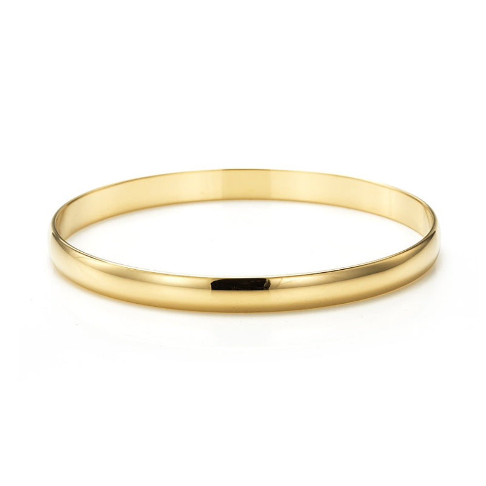 A 7mm wide 18ct heavy yellow gold plated plain bangle, showcasing its elegant design and luxurious finish, made in the USA.